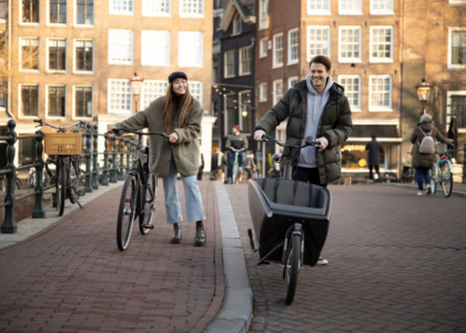 woman and man with bicycles on the crowded street